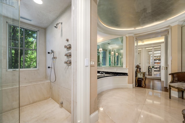 bathroom with tiled shower and tile patterned floors