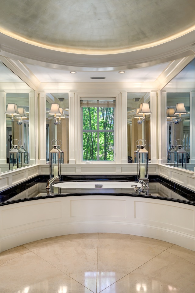 bathroom featuring tile patterned flooring and a raised ceiling