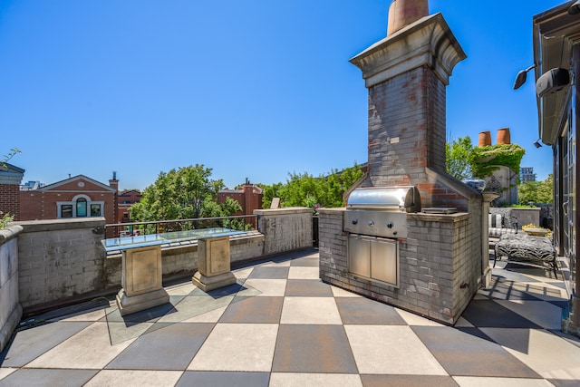 view of patio / terrace featuring an outdoor kitchen and a grill