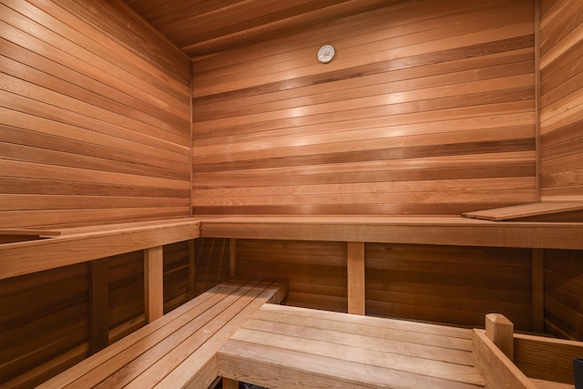 view of sauna featuring wooden walls