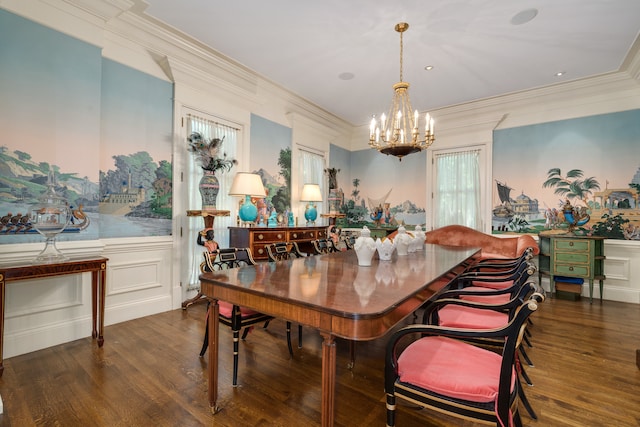 dining space with dark wood-type flooring, an inviting chandelier, and ornamental molding