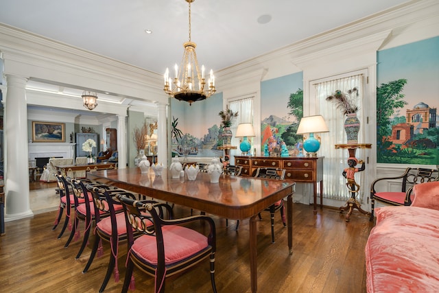 dining room with ornamental molding, dark wood-type flooring, decorative columns, and a notable chandelier