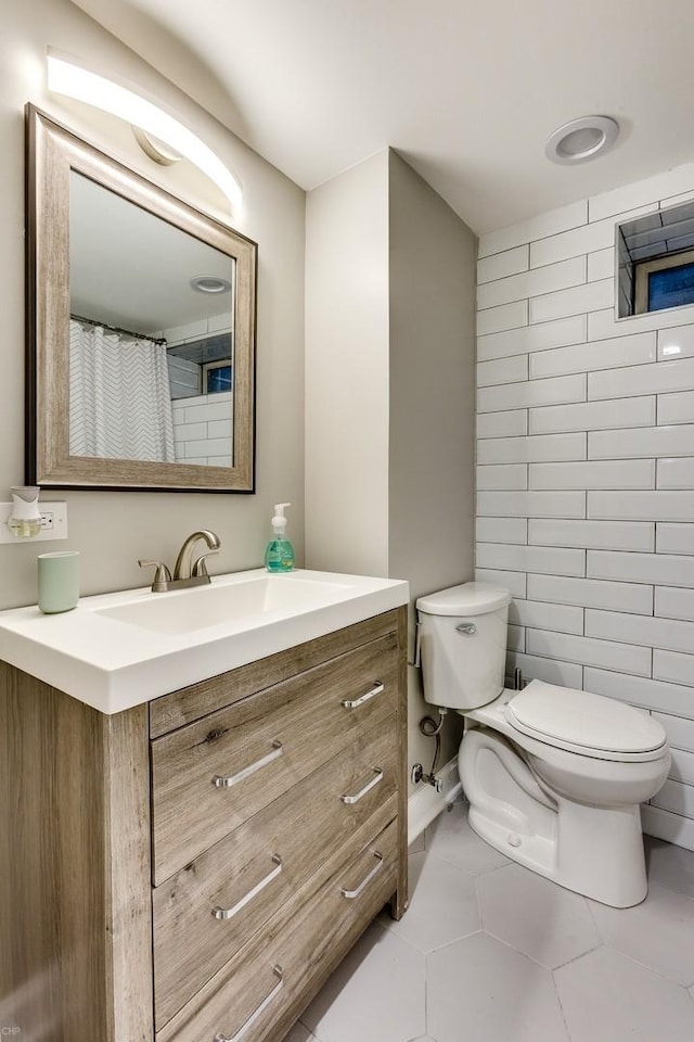 bathroom featuring tile patterned flooring, vanity, and toilet