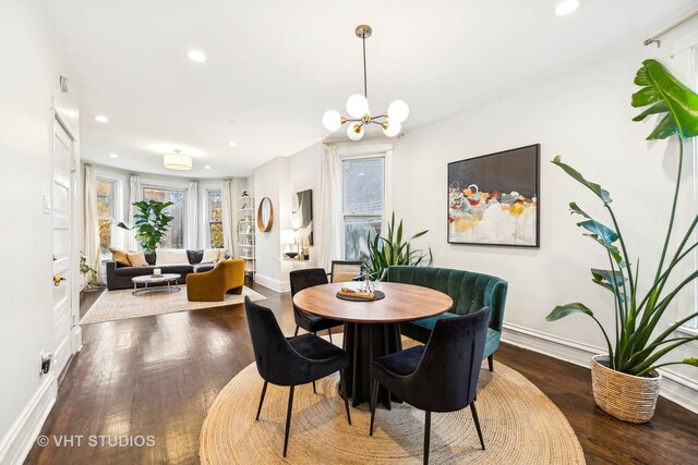 dining area featuring a chandelier and wood-type flooring