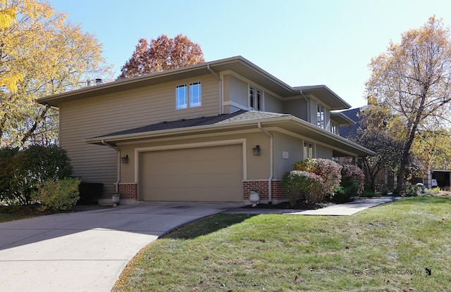 view of front of house with a garage and a front yard