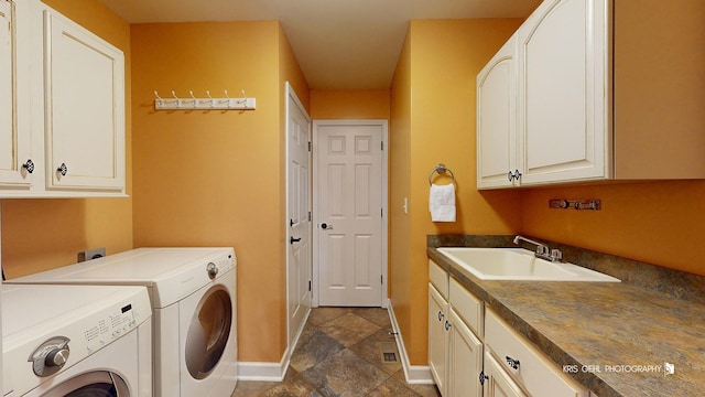 laundry room with cabinets, sink, and washer and dryer