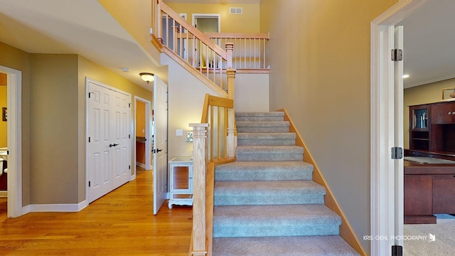 stairway featuring wood-type flooring