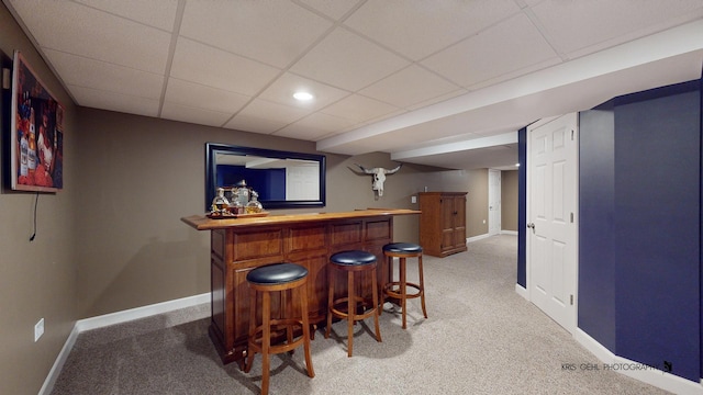 bar with a drop ceiling and carpet