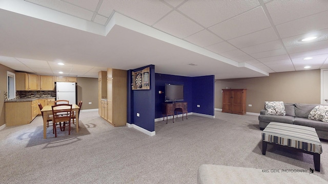 living room featuring light colored carpet and a paneled ceiling