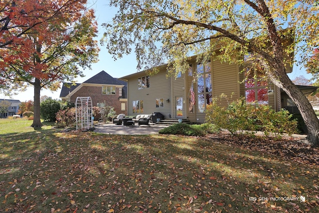 back of house featuring a patio and a yard