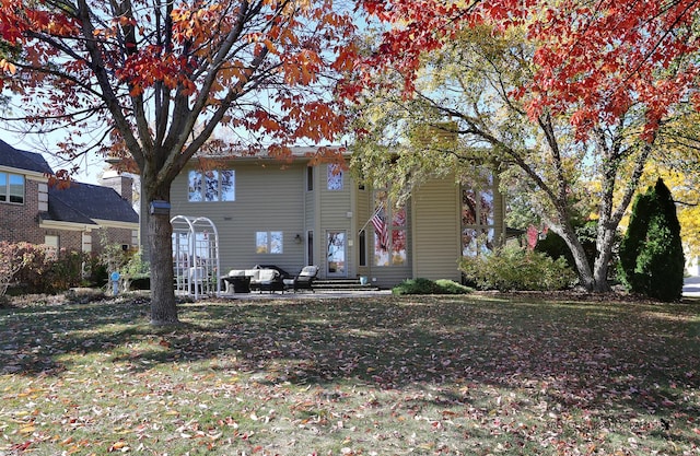 back of house featuring a lawn