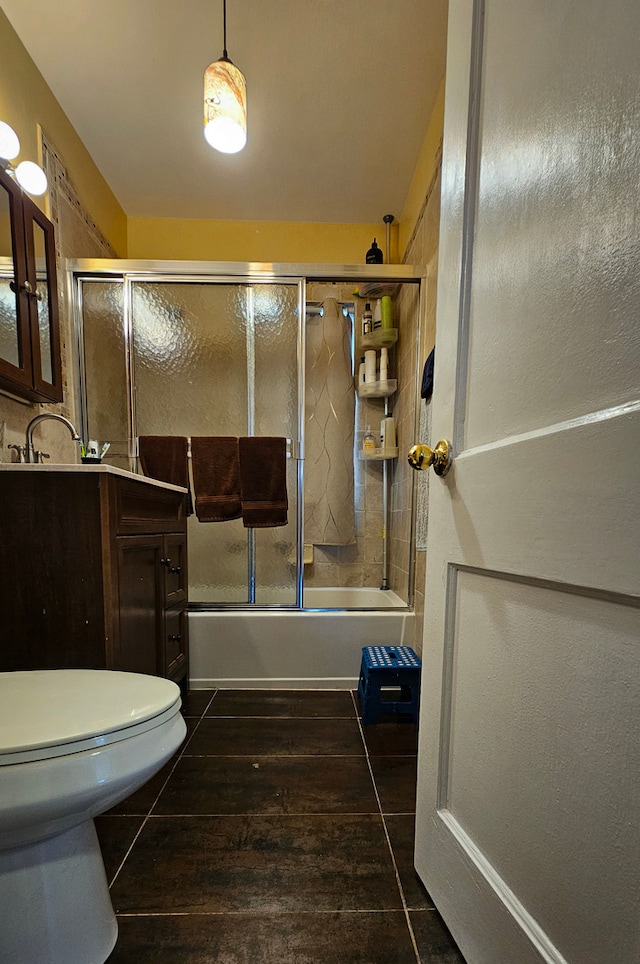 full bathroom with vanity, combined bath / shower with glass door, and toilet