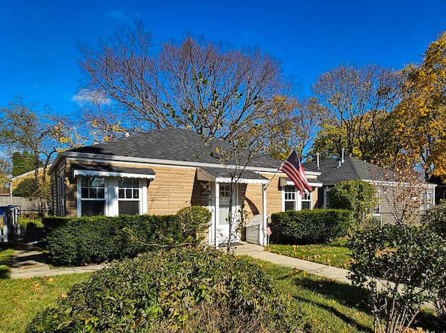 bungalow-style home featuring roof with shingles