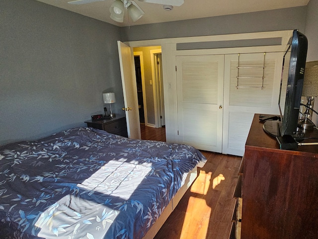 bedroom featuring wood-type flooring, a closet, and ceiling fan