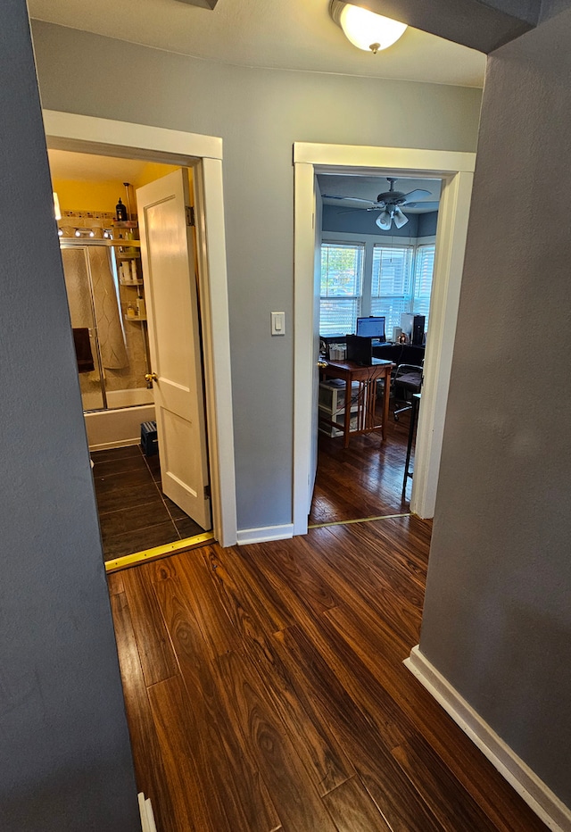 corridor with dark wood-type flooring