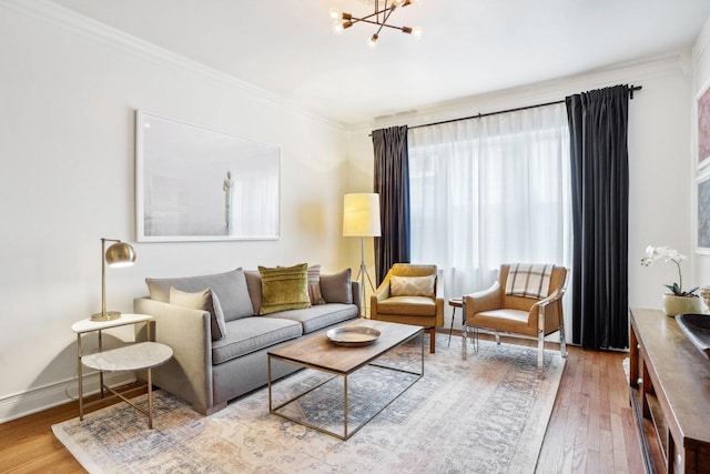 living room with crown molding, hardwood / wood-style floors, and a notable chandelier