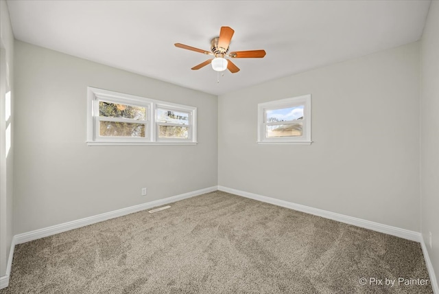 spare room featuring carpet and ceiling fan