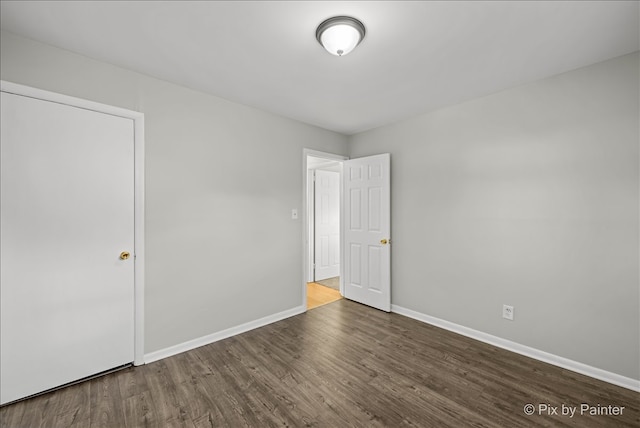 unfurnished room with wood-type flooring