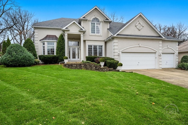 view of front of property with a front yard and a garage