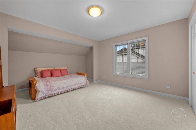 bedroom featuring carpet and vaulted ceiling