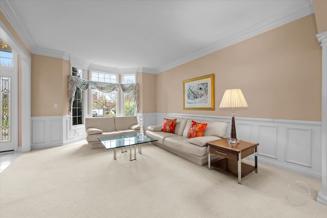 carpeted living room featuring decorative columns and ornamental molding