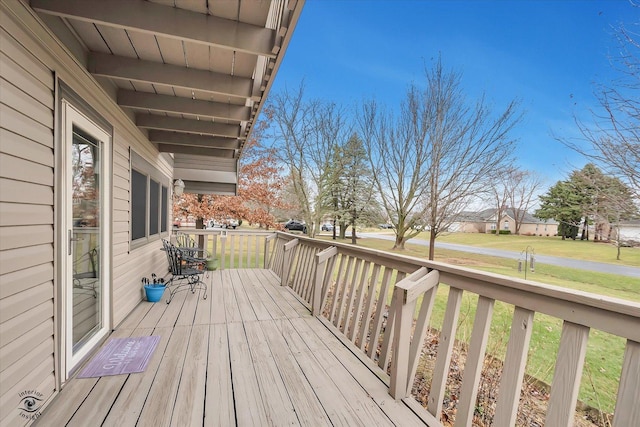 wooden terrace featuring a yard