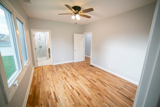 unfurnished bedroom featuring ceiling fan, light hardwood / wood-style floors, and ensuite bathroom