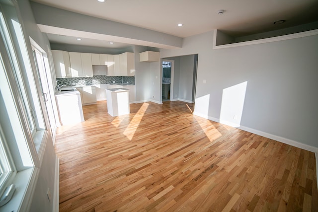 unfurnished living room with light hardwood / wood-style flooring