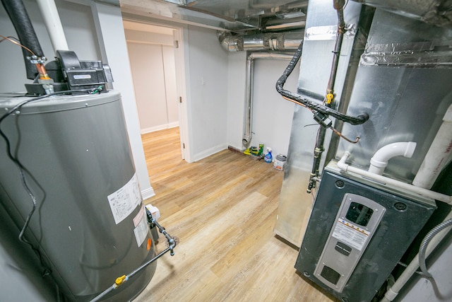 utility room with heating unit and water heater