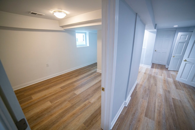 corridor with light hardwood / wood-style floors