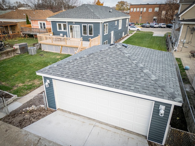 exterior space featuring a lawn and central AC