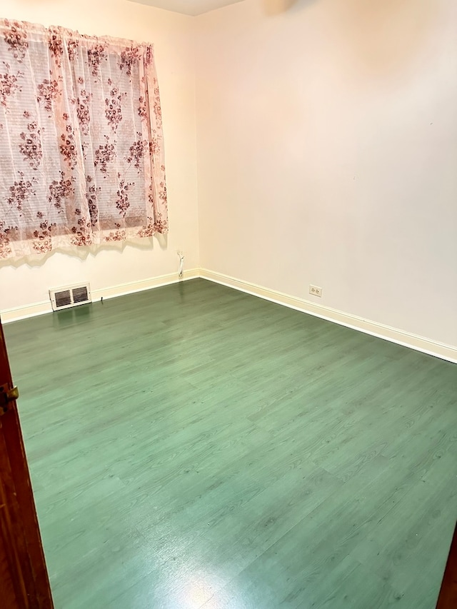 empty room featuring dark hardwood / wood-style flooring