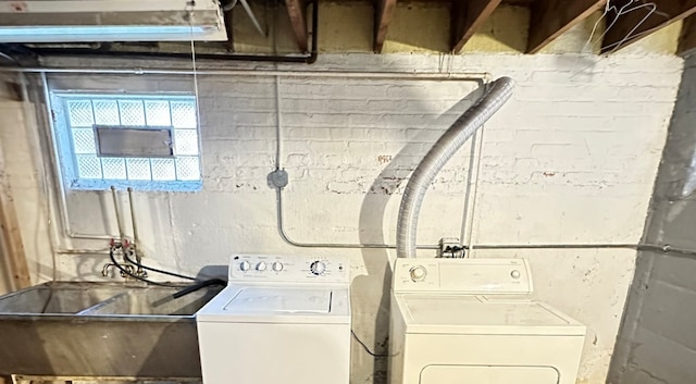 washroom featuring washer and clothes dryer and sink