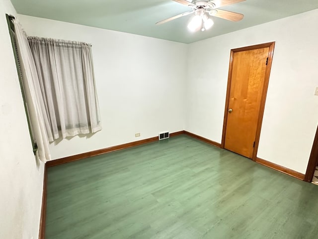 empty room with ceiling fan and wood-type flooring