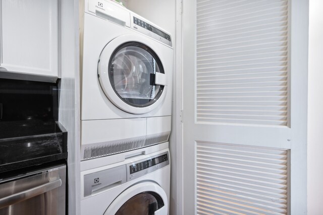 laundry room featuring stacked washer and clothes dryer