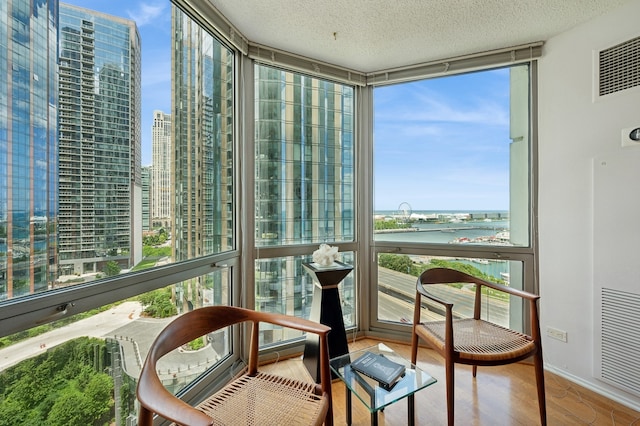 sunroom / solarium with a wealth of natural light and a water view