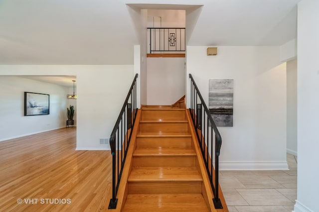 staircase with wood-type flooring