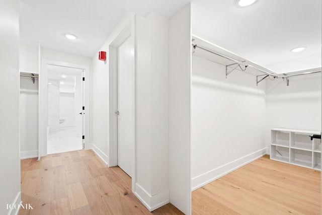 spacious closet with light wood-style floors