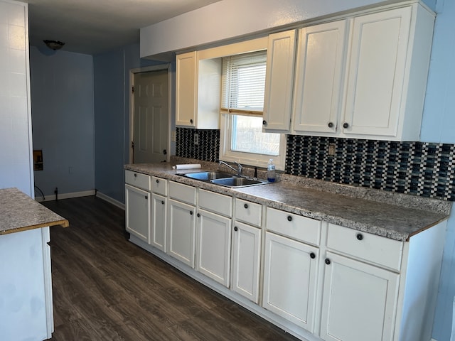 kitchen featuring white cabinetry, sink, dark hardwood / wood-style flooring, and tasteful backsplash