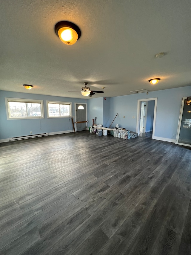 interior space featuring ceiling fan, a baseboard radiator, a textured ceiling, and dark hardwood / wood-style flooring