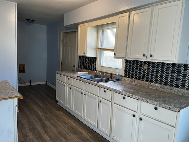 kitchen featuring white cabinetry, sink, backsplash, and dark hardwood / wood-style flooring