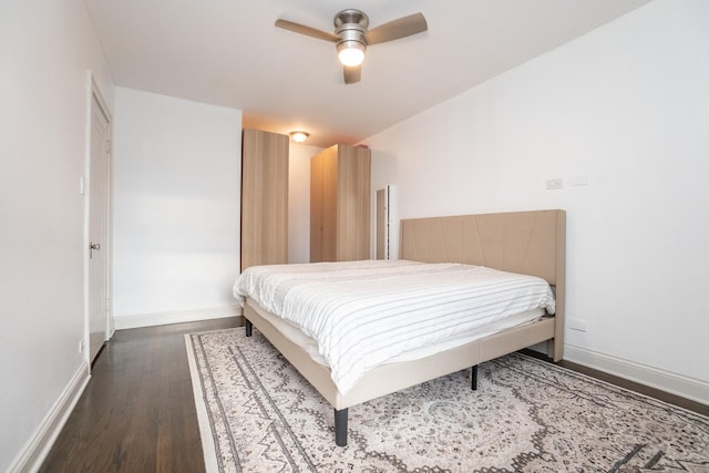 bedroom with ceiling fan and dark wood-type flooring