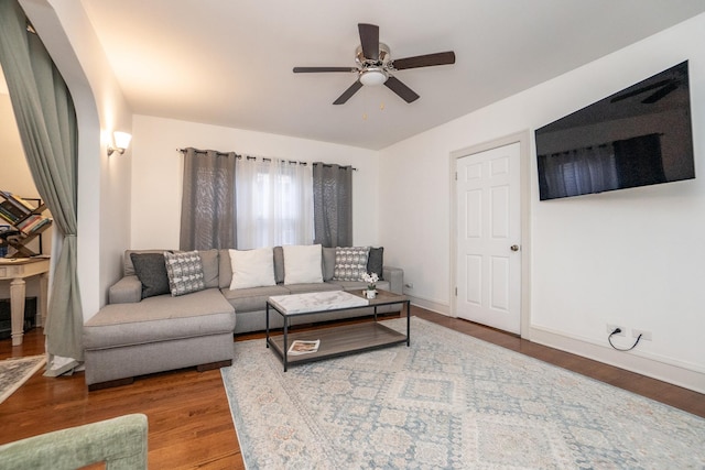 living room with ceiling fan and wood-type flooring