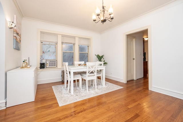 dining area featuring cooling unit, a chandelier, light hardwood / wood-style floors, and ornamental molding