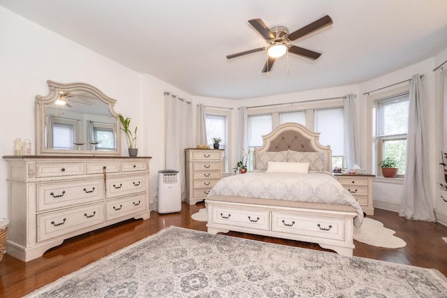 bedroom with dark hardwood / wood-style flooring and ceiling fan