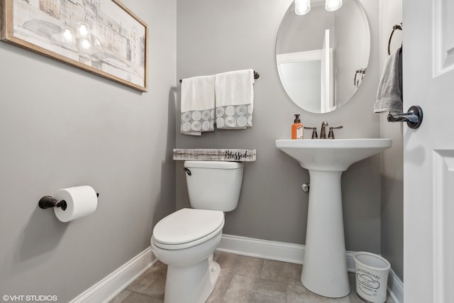 bathroom with tile patterned flooring and toilet