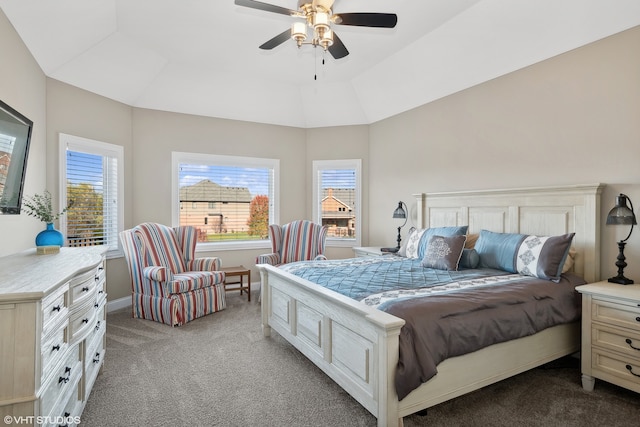 bedroom featuring ceiling fan, vaulted ceiling, and light colored carpet