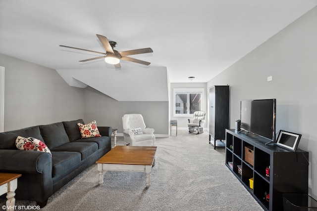 carpeted living room with ceiling fan and vaulted ceiling