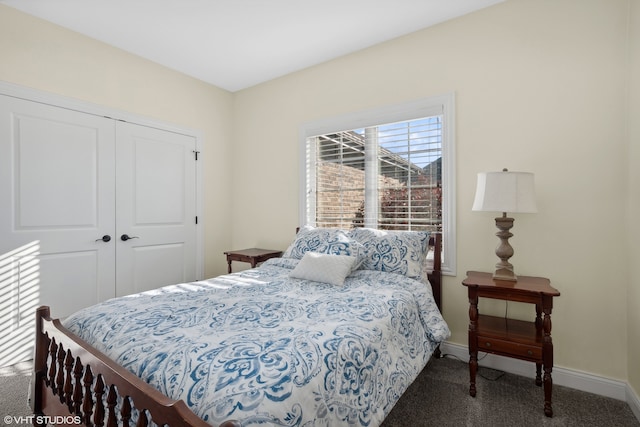 bedroom with dark carpet and a closet