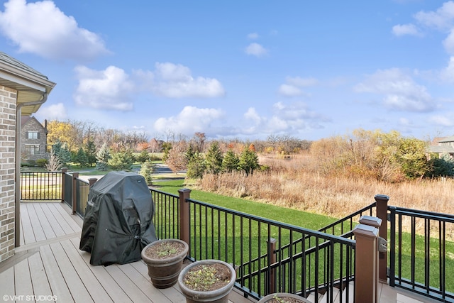 deck featuring area for grilling and a lawn